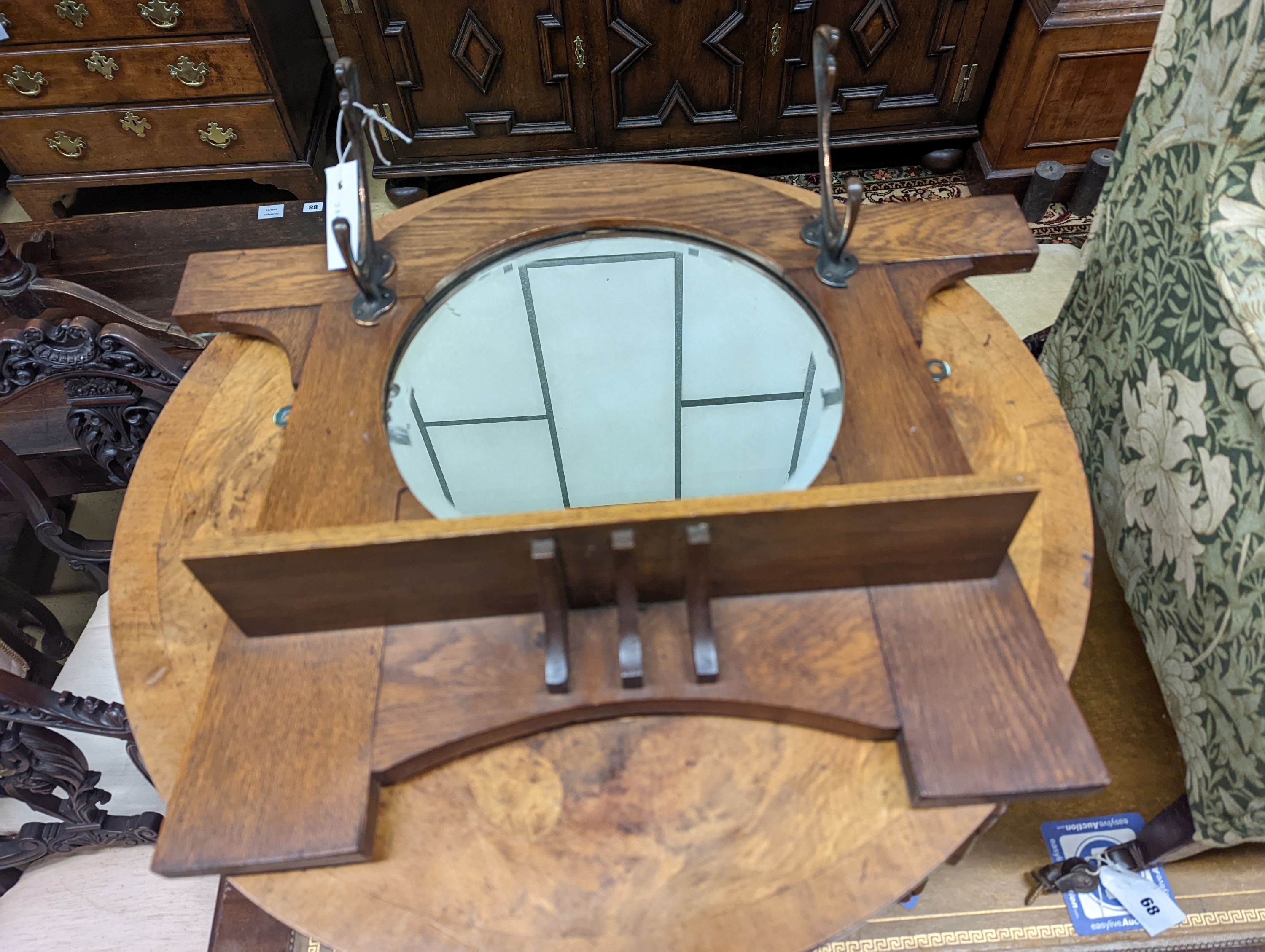 A Queen Anne revival circular walnut occasional table, diameter 60cm, height 40cm together with an Arts & Crafts mirrored oak coat rack